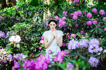 fashion beautiful girl in a flowers garden