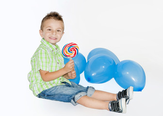 Smiley little boy with lollipop