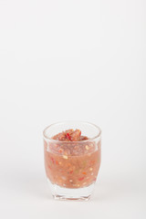chili paste in glass on white paper background