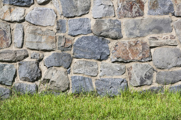 stone wall and green grass