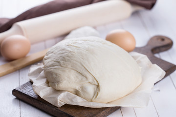 Dough on wooden board