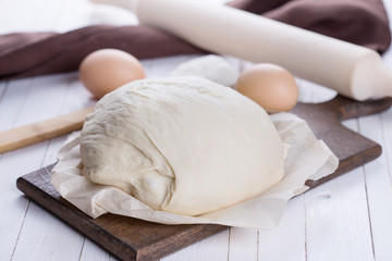 Dough on wooden board