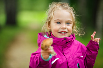 Happy little girl with a mushroom