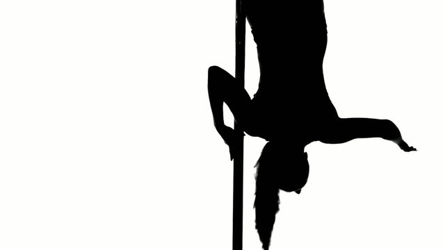 Silhouette of a sexy female pole dancing