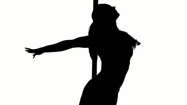 Silhouette of a sexy female pole dancing
