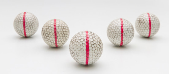 Five Old golf balls.