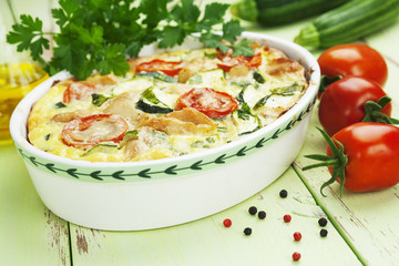 Zucchini baked with chicken, cherry tomatoes and herbs
