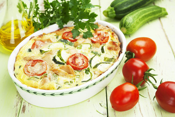 Zucchini baked with chicken, cherry tomatoes and herbs