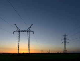 Large transmission towers at sunset