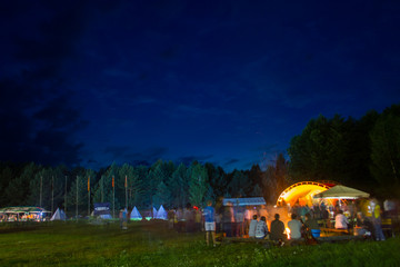 Night party near the fire in the forest.