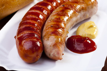 Roasted sausage with bread served on a paper tray