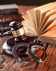 Wooden gavel and books on wooden table