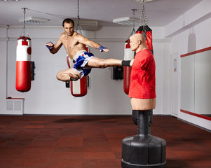 Kickbox fighter working with the dummy