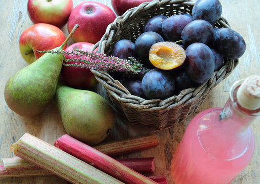 Variety of autumn fruits - apples, pears, plums and rhubarb
