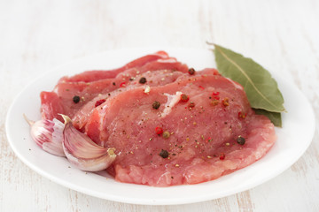 raw pork with garlic on plate