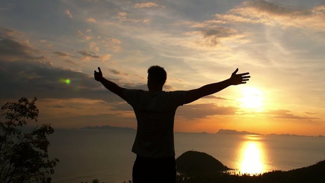 Man on Top of Mountain. Uplifting Freedom Concept. Slow Motion.