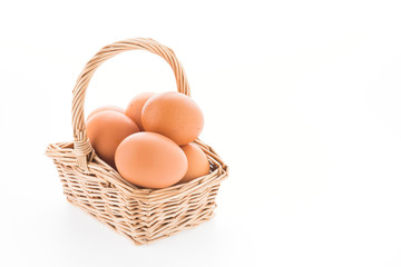 Eggs in basket isolated on white background
