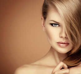 Close-up of lovely blue eyed female with professional makeup