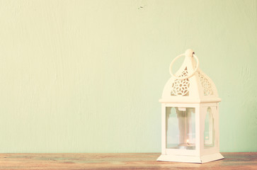 white lantern over wooden table. vinatge effect