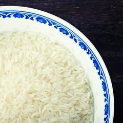 blue bowl of uncooked white rice