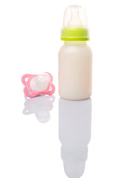 Baby pacifier and a bottle of baby formula milk