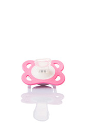 A pink pacifier over white background