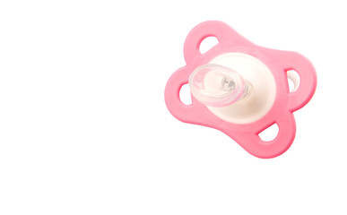 A pink pacifier over white background
