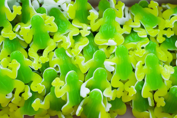 Green jelly candies in the form of frogs on the counter