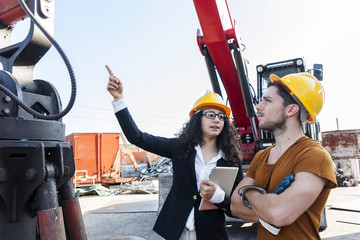 young female engineer talks about working with a worker
