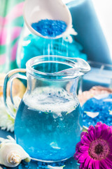Preparing relaxing spa bath aromatic pouring salt