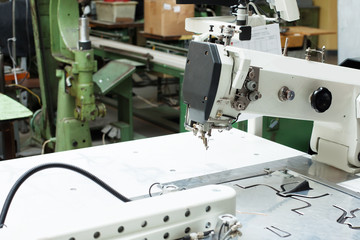 Close-up of sewing machine and patterns for shoes