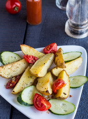 baked potato and raw vegetables on a white plate