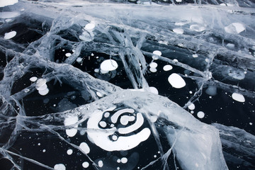 Ice cracks and air bubbles on Baikal surface