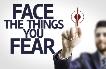Business man pointing the text: Face the Things you Fear
