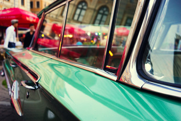 Evening city lights in glasses vintage car