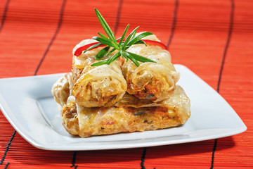 fried spring rolls on red bamboo mat