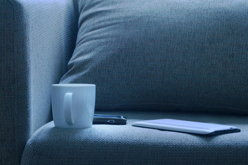 Bed with tablet pc cell phone and a cup of coffe
