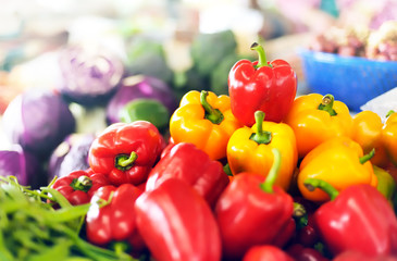 Red and yellow organic sweet peppers on vegetables market