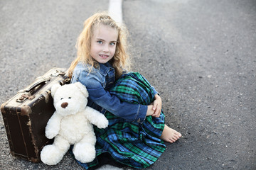 Young girl sitting on the street