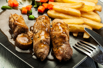 Pork rolls with french fries with vegetable