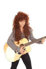 Fototapeta premium woman red hair guitar look down