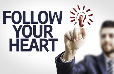Business man pointing the text: Follow your Heart