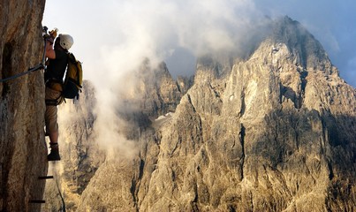 climber on via ferrata or klettersteig in Italy - obrazy, fototapety, plakaty