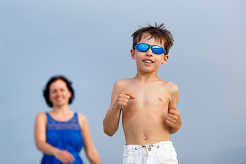 Mother and son on tropical beach