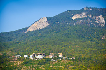 Fototapeta na wymiar Crimean mountain landscape. Green trees, Dwelling houses