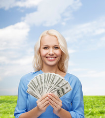 smiling young woman with us dollar money