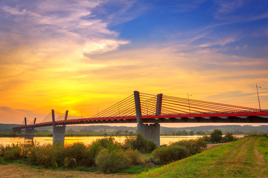 Cable stayed bridge over Vistula river in Poland at sunset.