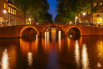 Night city view of Amsterdam canals and seven bridges