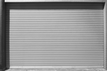 grunge metallic roller white shutter door at night