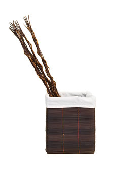 Decorative basket and sticks isolated on white background